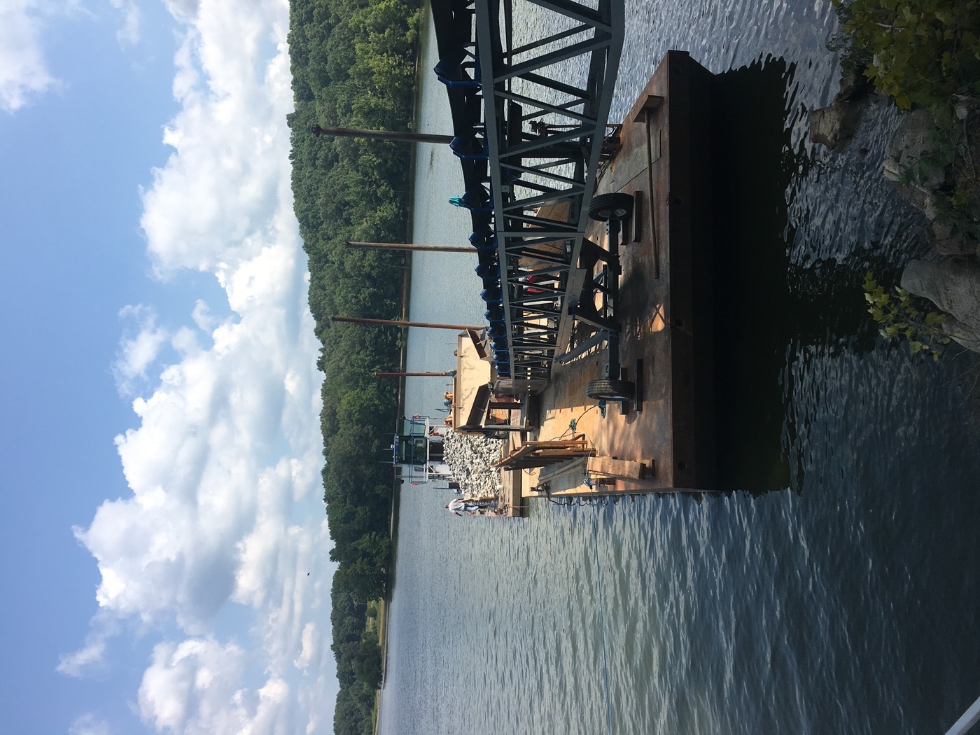 Twin Lakes' custom-built work barge loaded with riprap stone, conveyor rig and push boat on Kentucky Lake